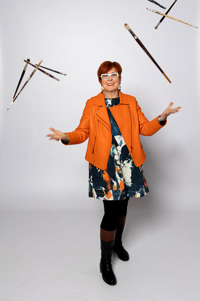 Sue Mac Dougall throwing paint brushes in the air