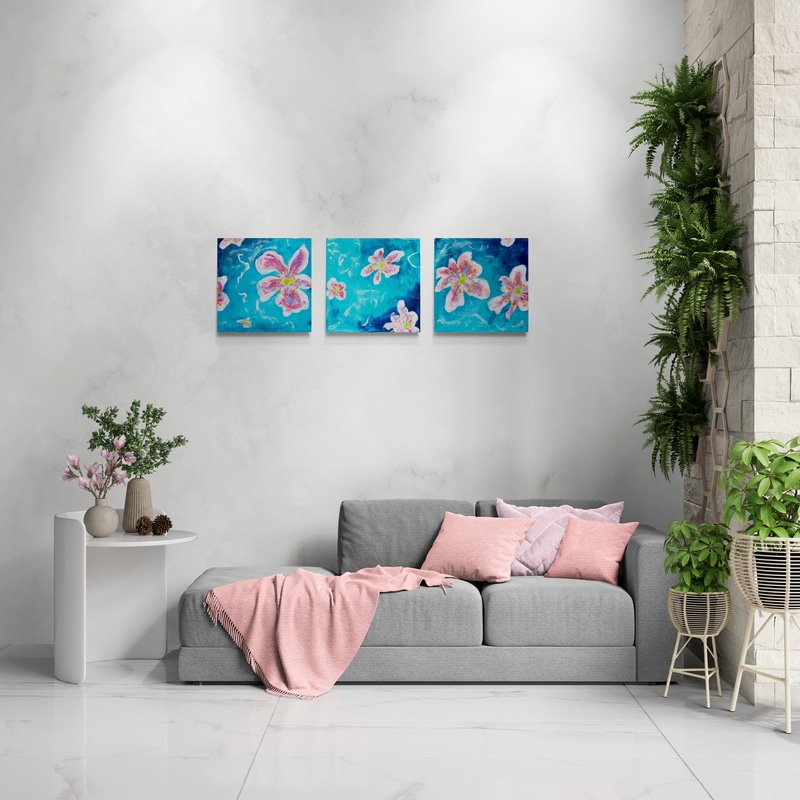 Vivid Melody I, II and III by Sue Mac Dougall hung side by side above a sofa in a modern living room, blue and pink abstract florals with resin and gold mirrored edges